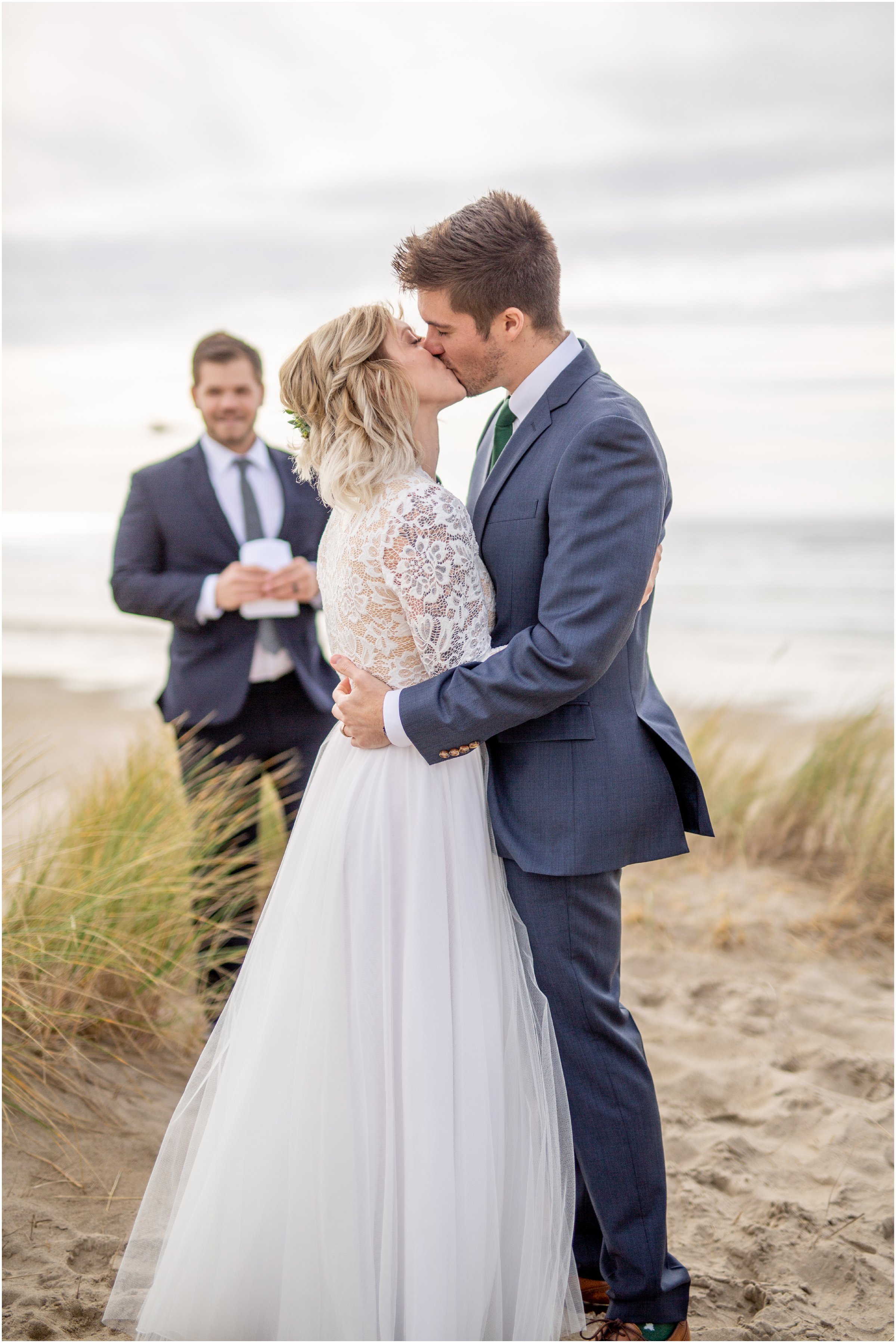 bride and groom share first kiss after their elopement on cannon beach