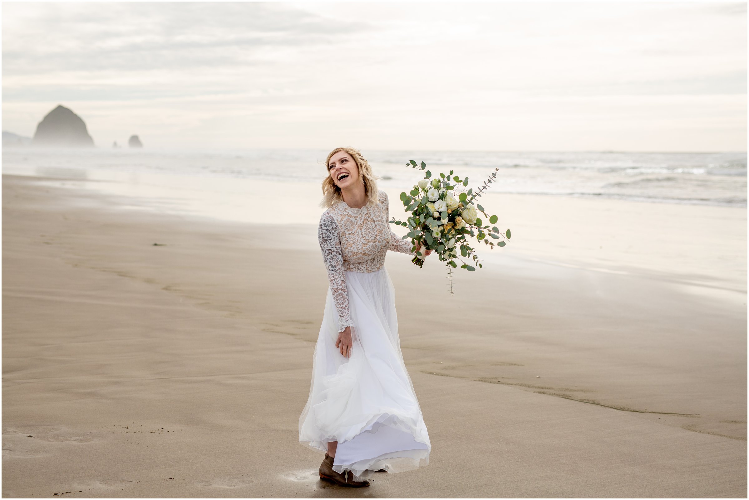 bride alone on the beach with haystack rock in the background after getting married