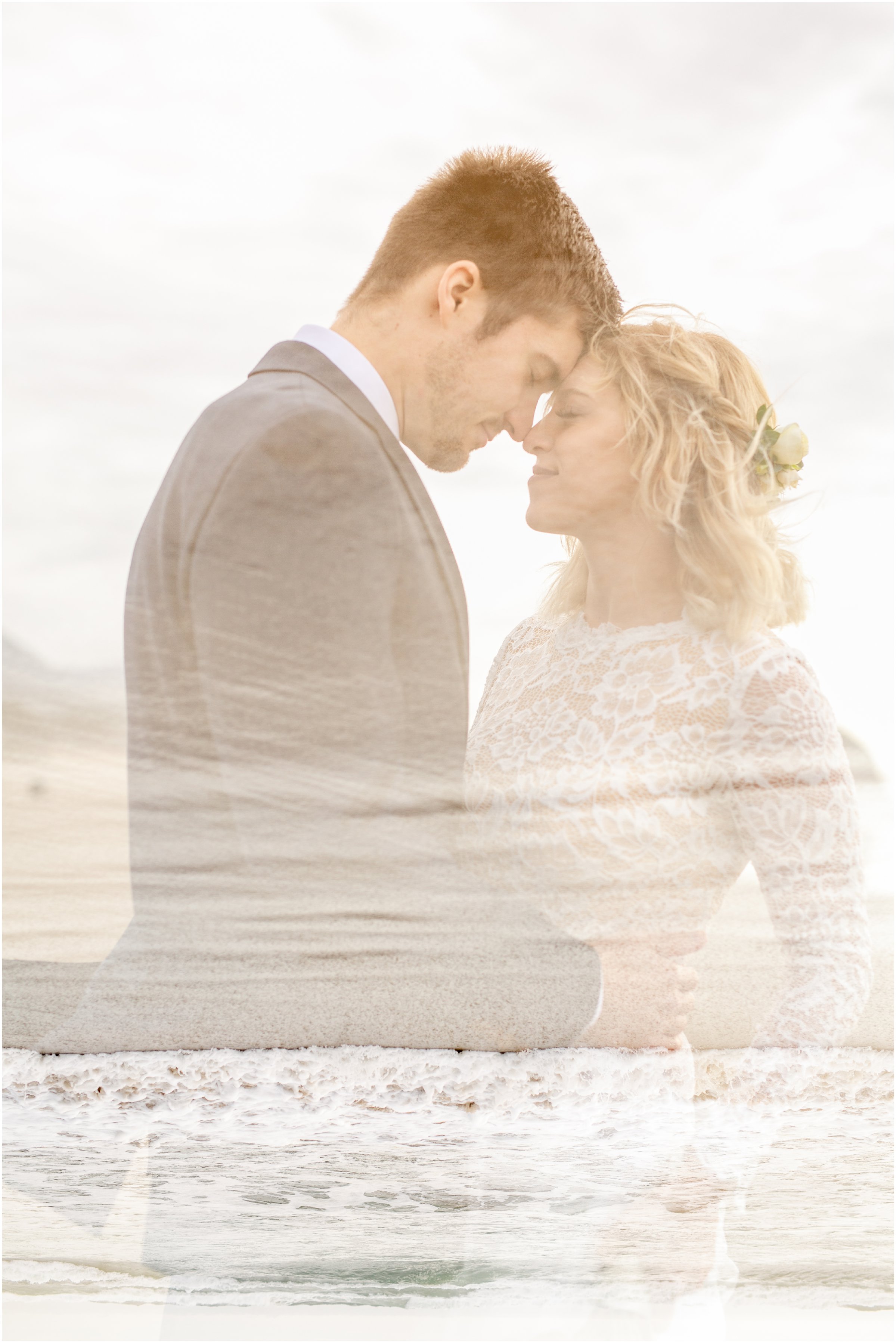 double exposure of bride and groom standing face to face with waves crashing in the background