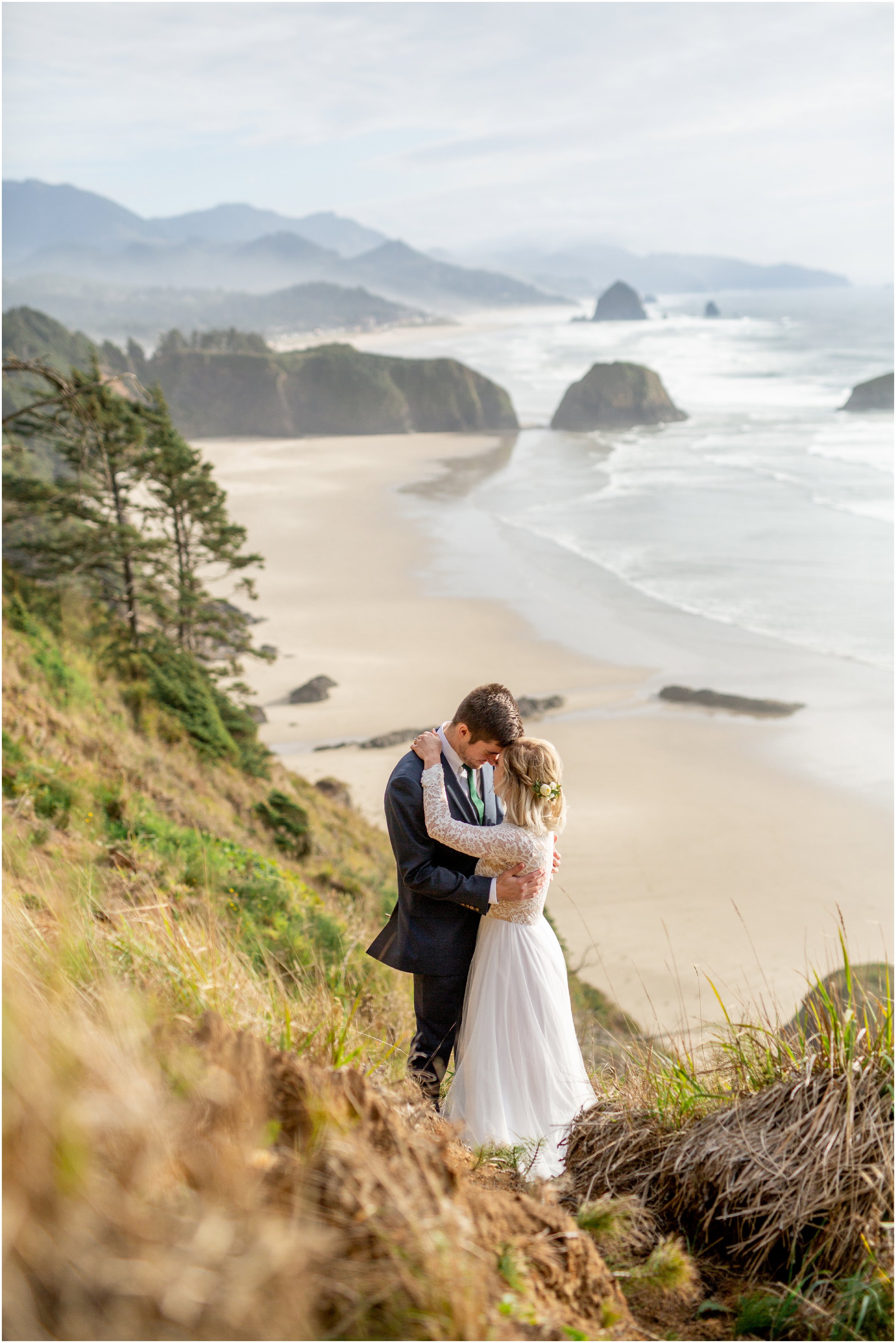 bride and groom on a hillside overlooking the beach in ecola state park