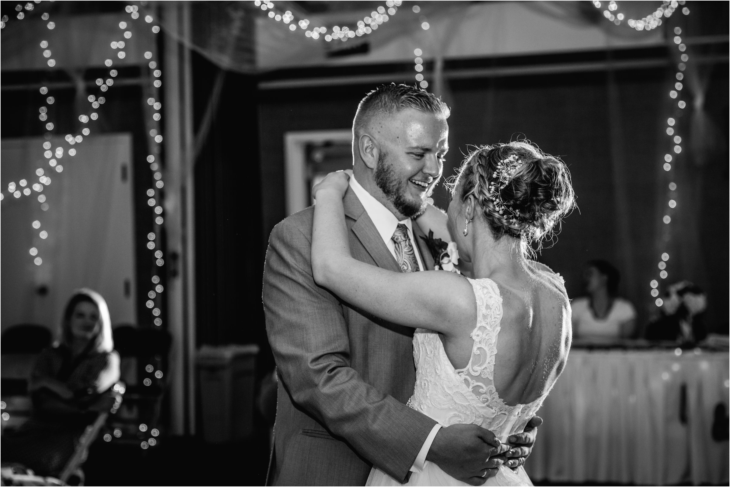 black and white photo of bride and groom dancing together at their wedding reception