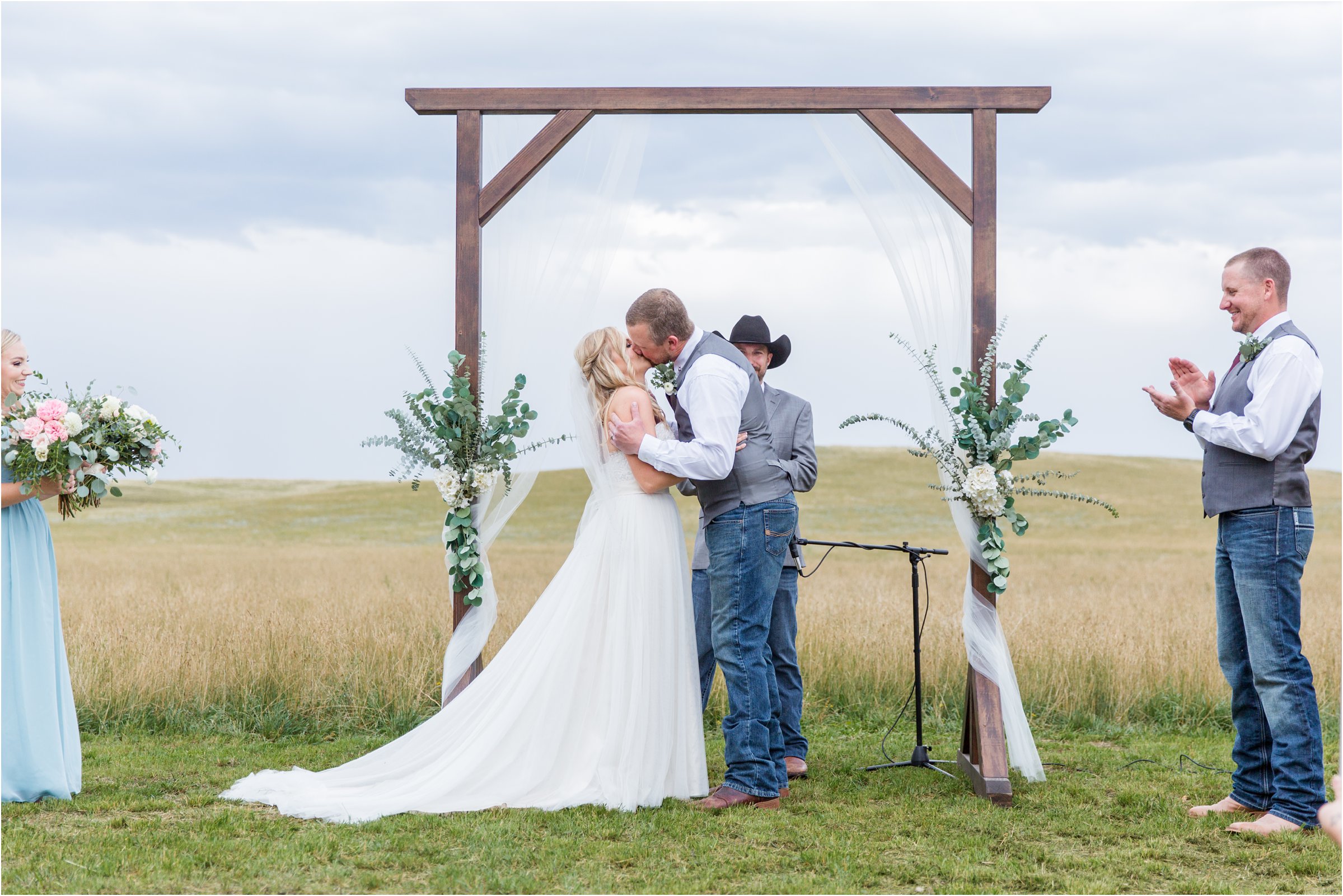 the bride and groom share their first kiss during their wyoming ceremony