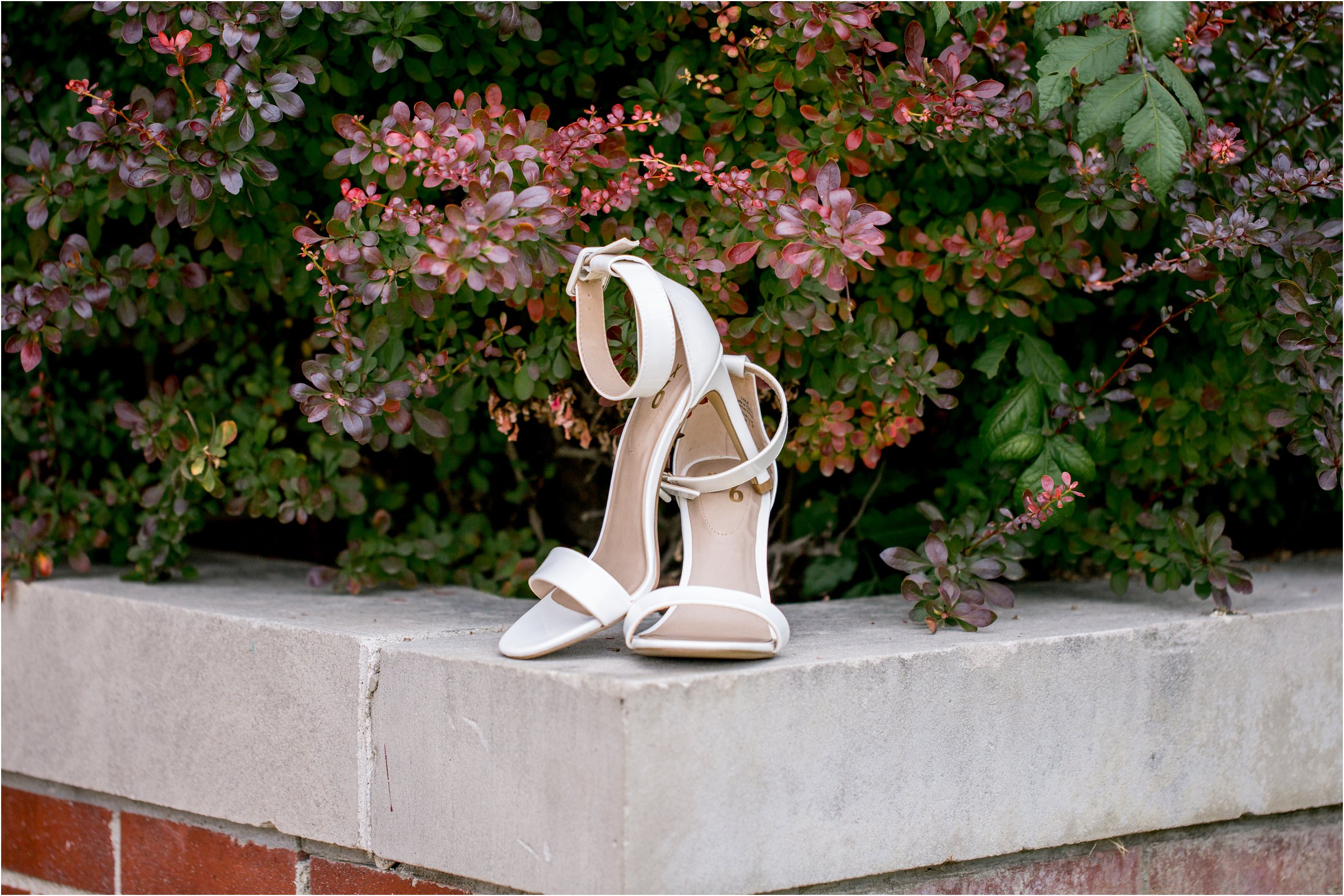 bride's shoes in front of colorful leaves