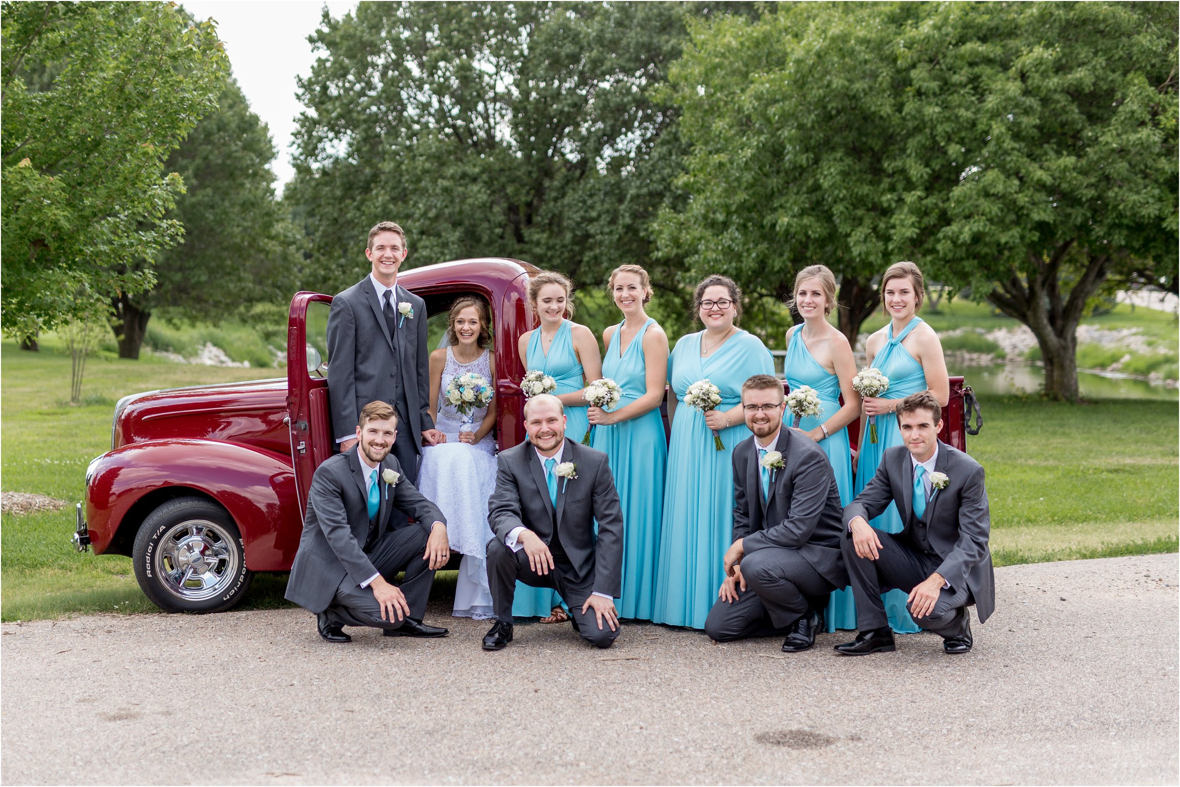 bridal party poses with classic red chevy pickup