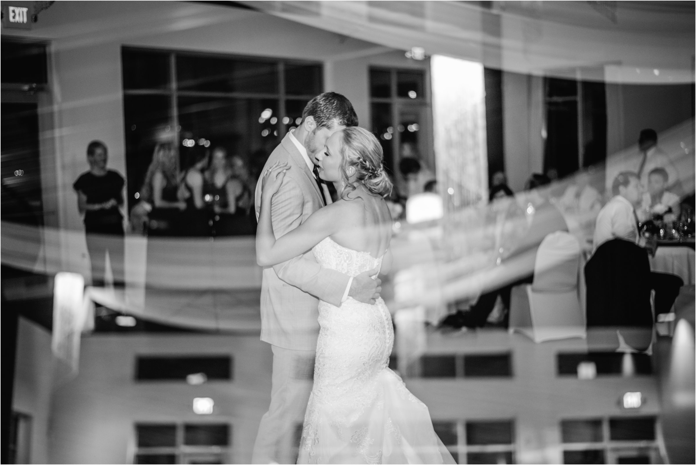 bride and groom dancing alone together on the dance floor with a double exposure of drapes