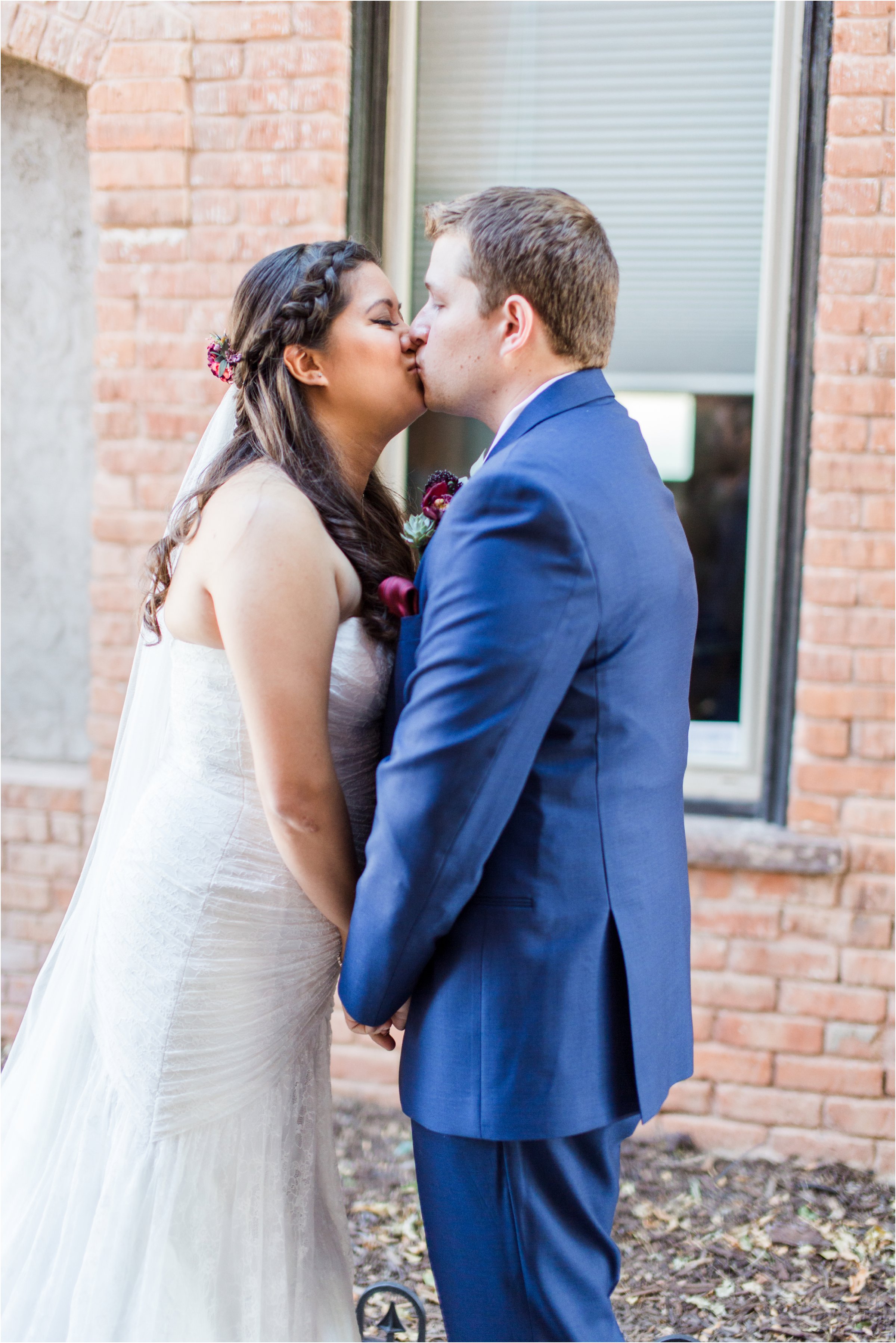 bride and groom kiss after first look in alleyway behind the loft music venue in colorado springs