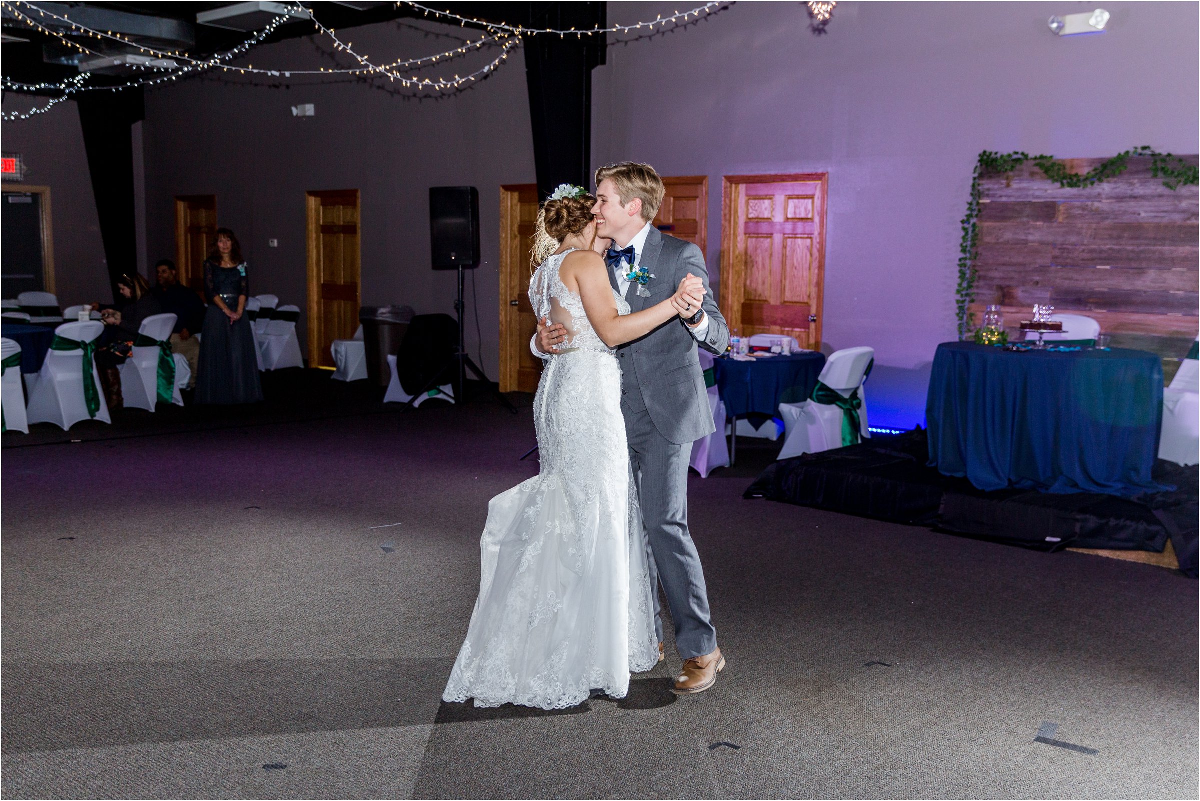 bride and groom dancing their first dance together as husband and wife at their wedding reception
