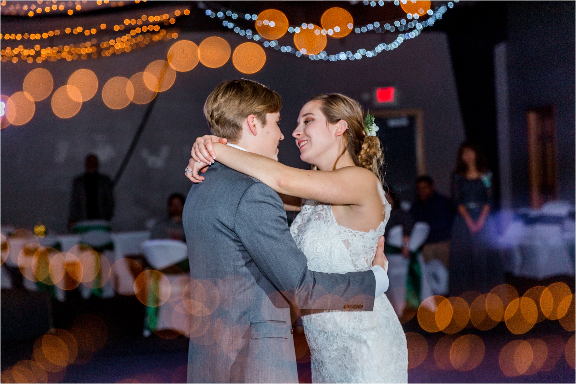 bride and groom dancing their first dance together as husband and wife at their wedding reception