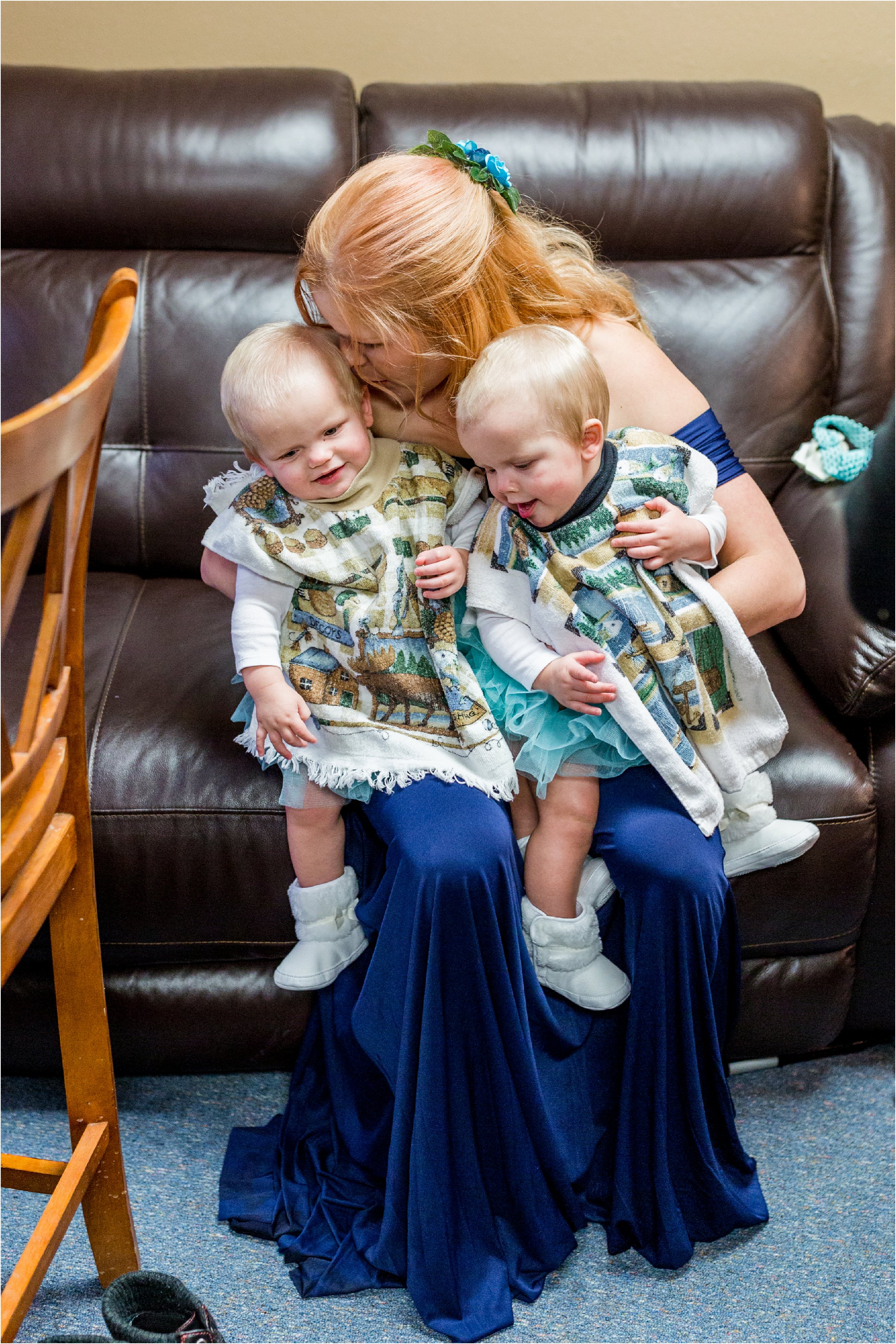 bridesmaid with her two twin daughters on a couch waiting for photos