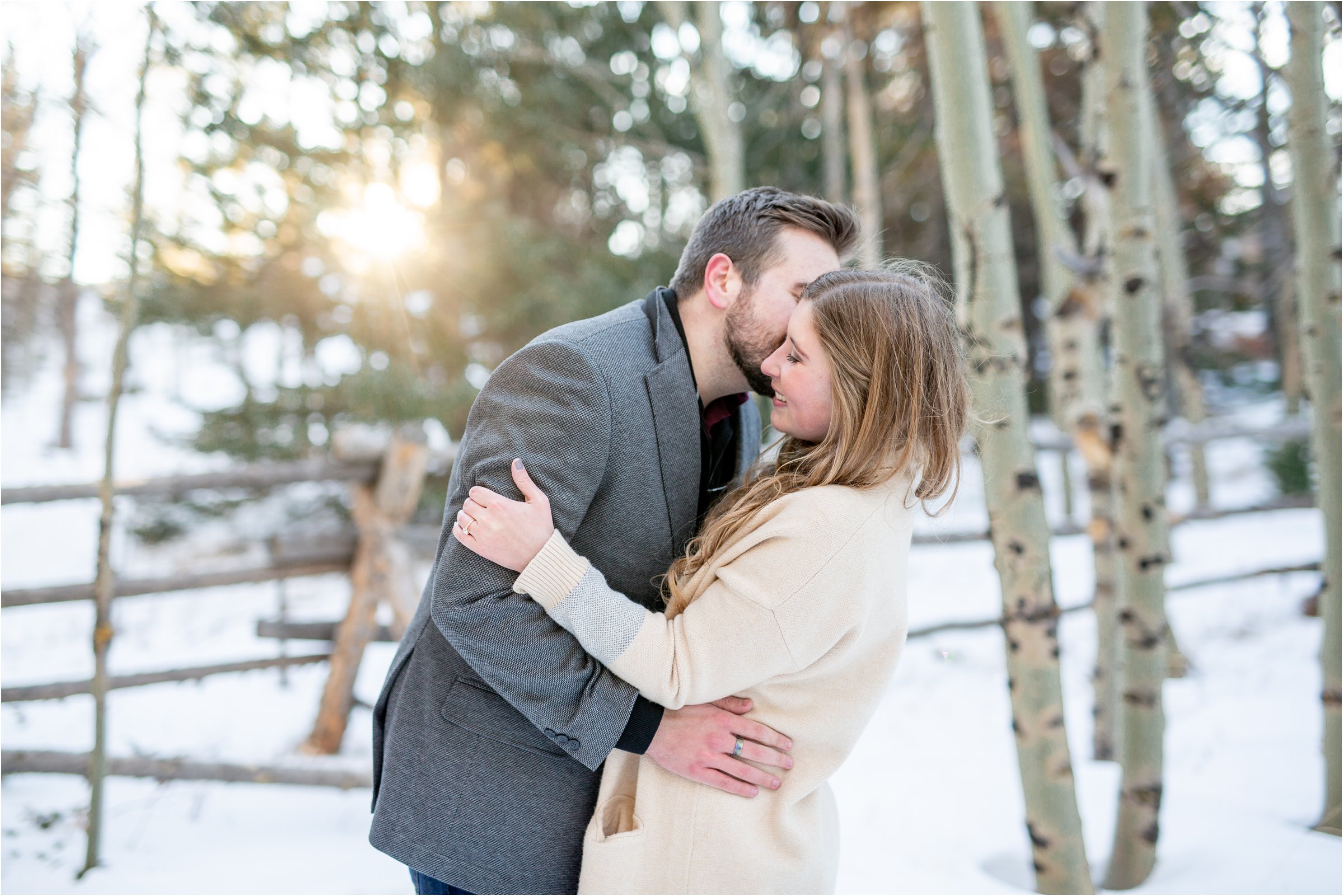 engaged couple kissing in an aspen grove with snow on the ground for their cheyenne engagement session