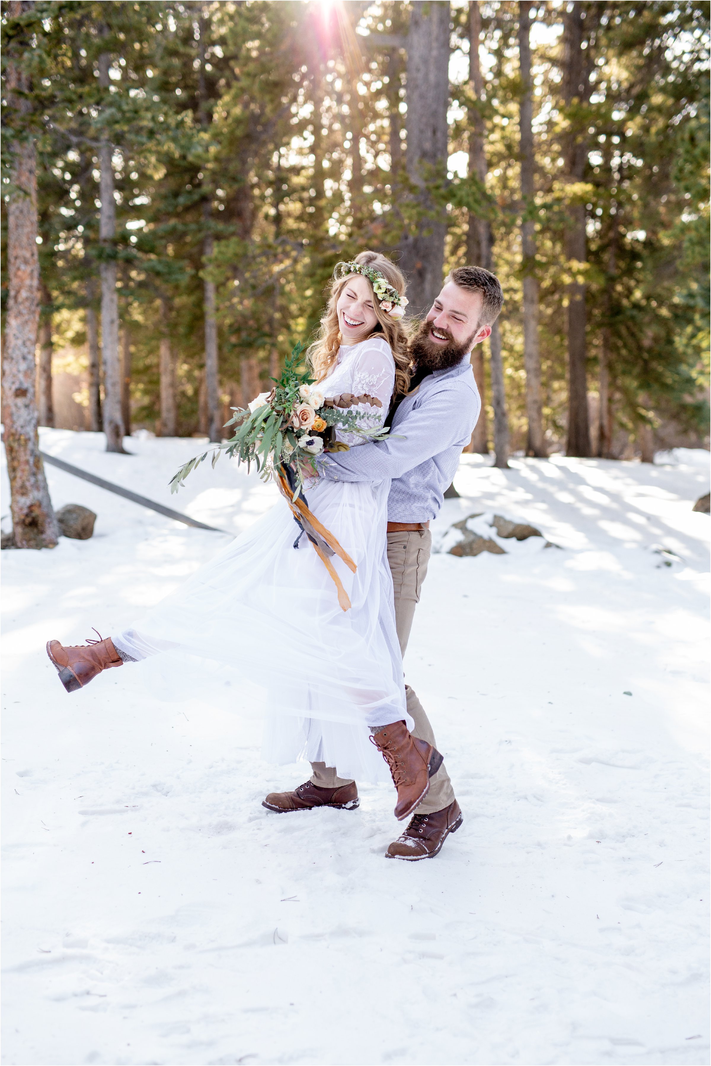 Groom swinging bride around playfully in mountain elopement