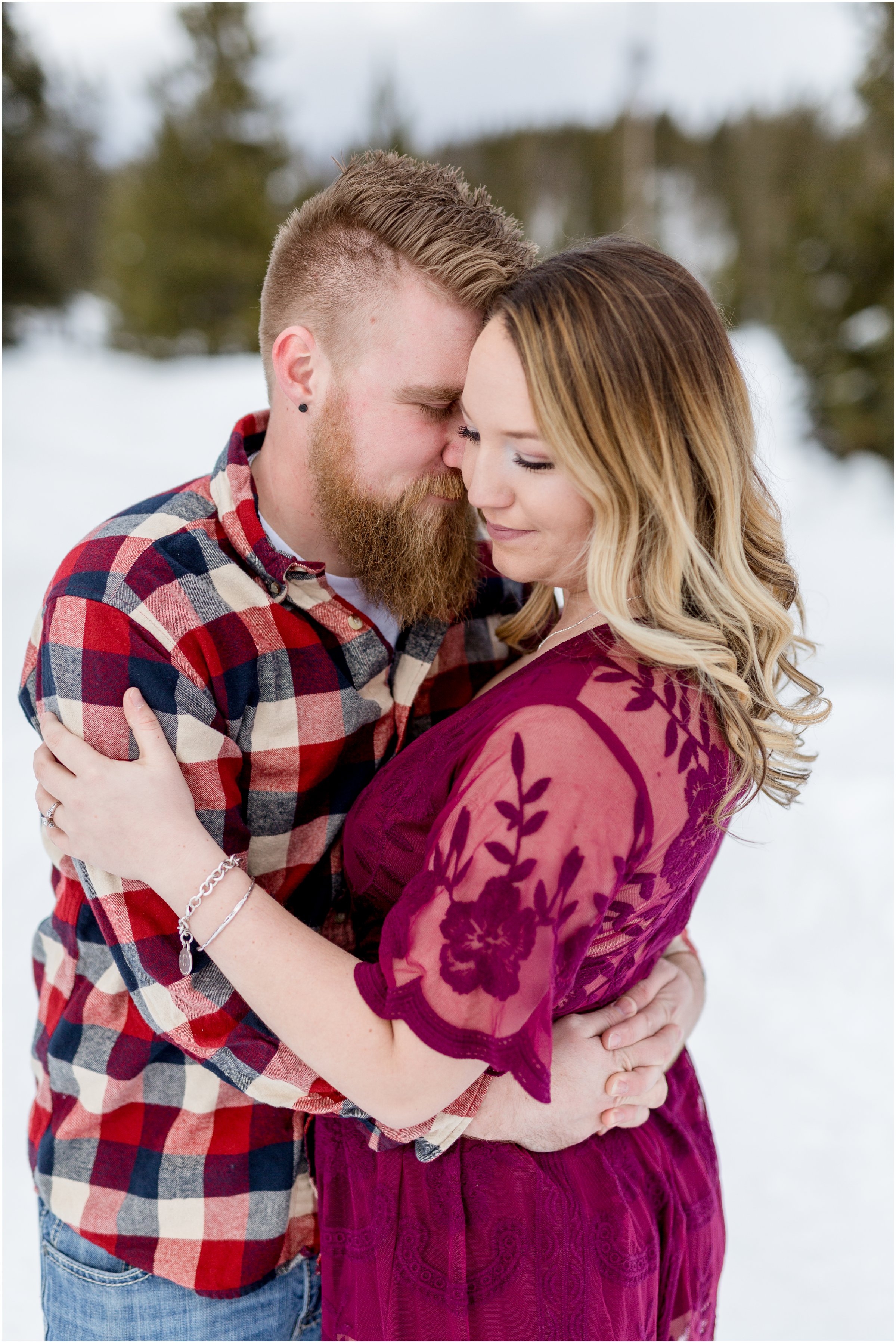 man in plaid and woman in red lace dress stand face to face for photos with their grand lake wedding photographer