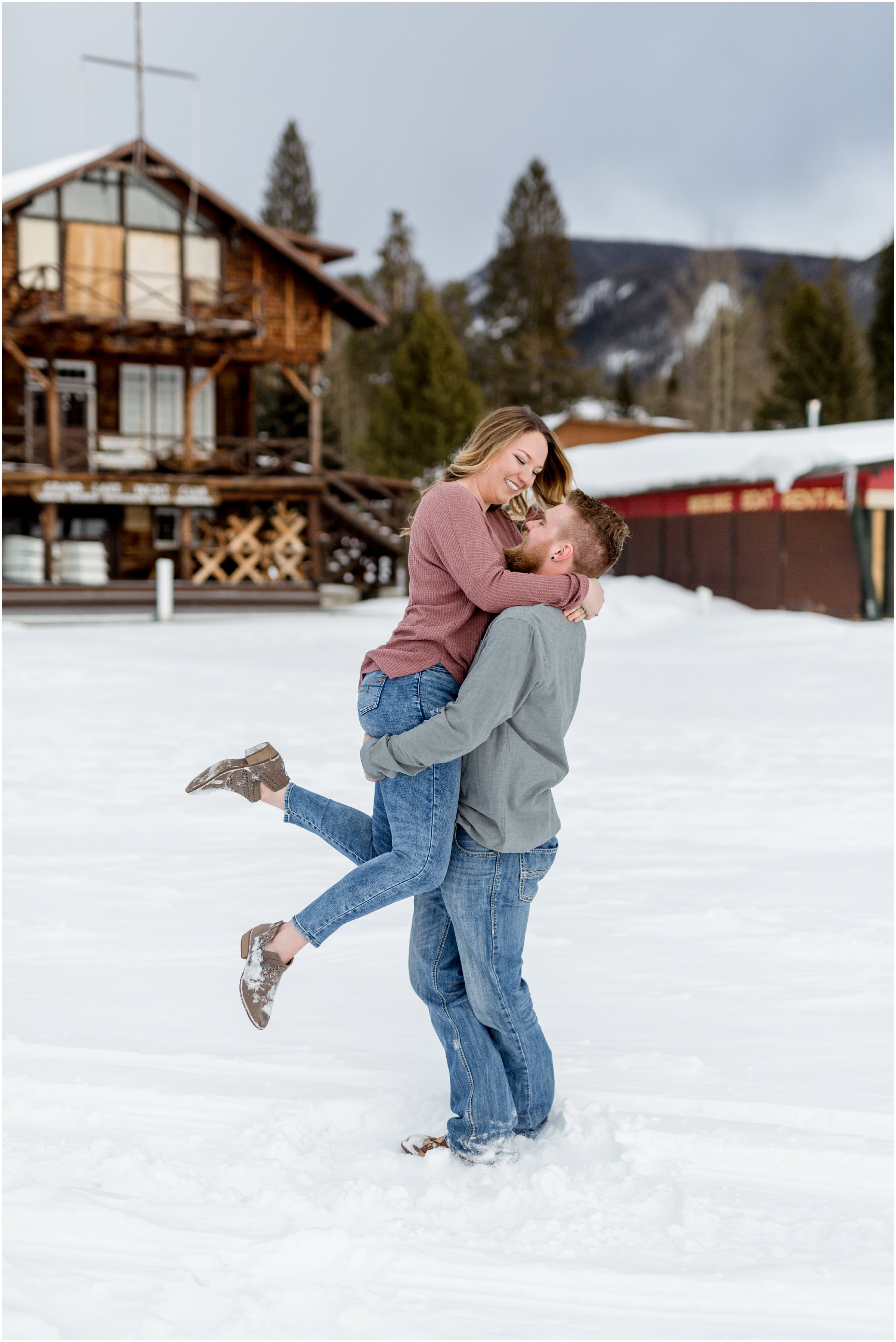 groom picks up bride and spins her around on grand lake for their session with their grand lake wedding photographer