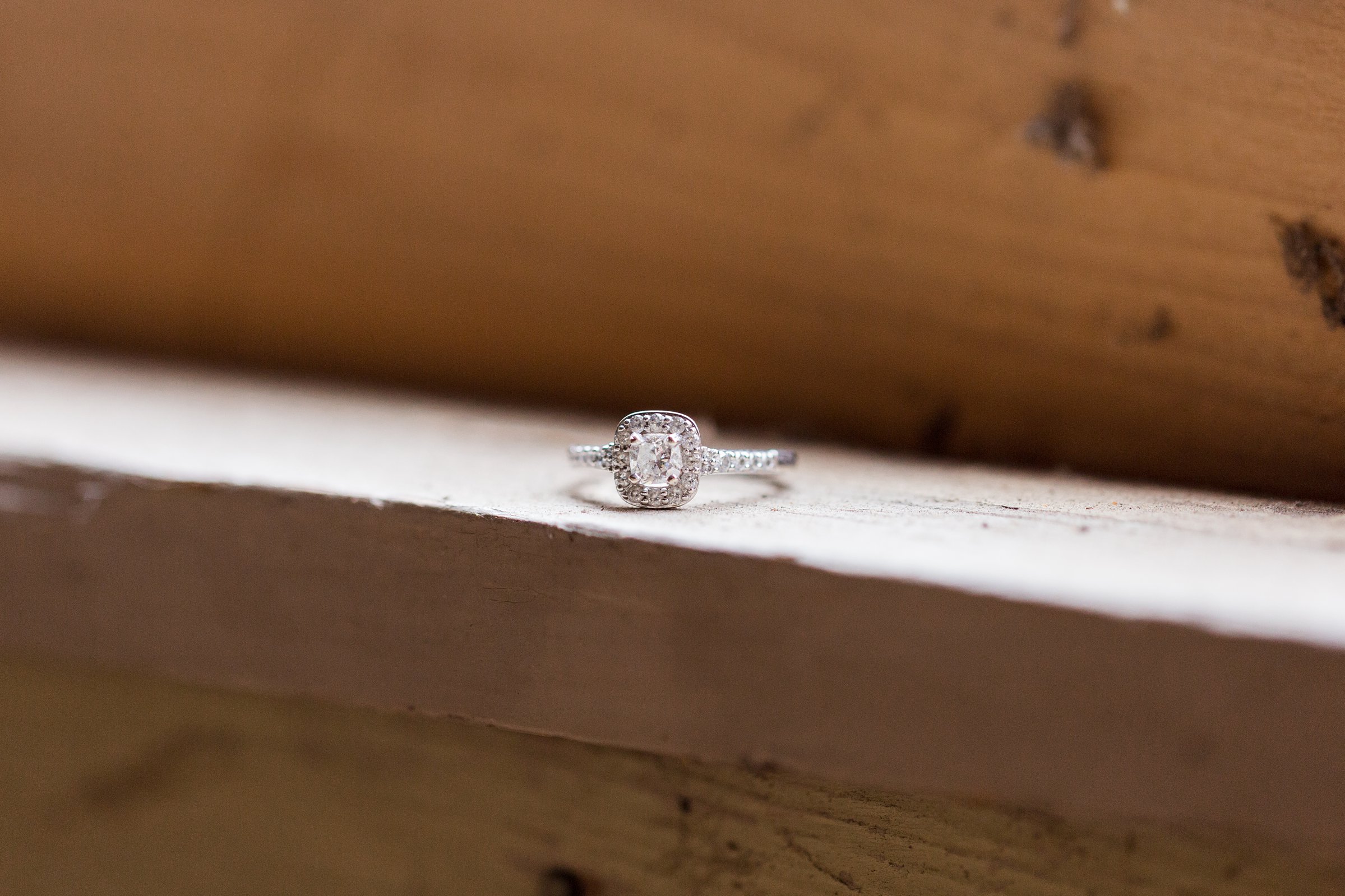 engagement ring sitting on wooden ledge for fort collins engagement session