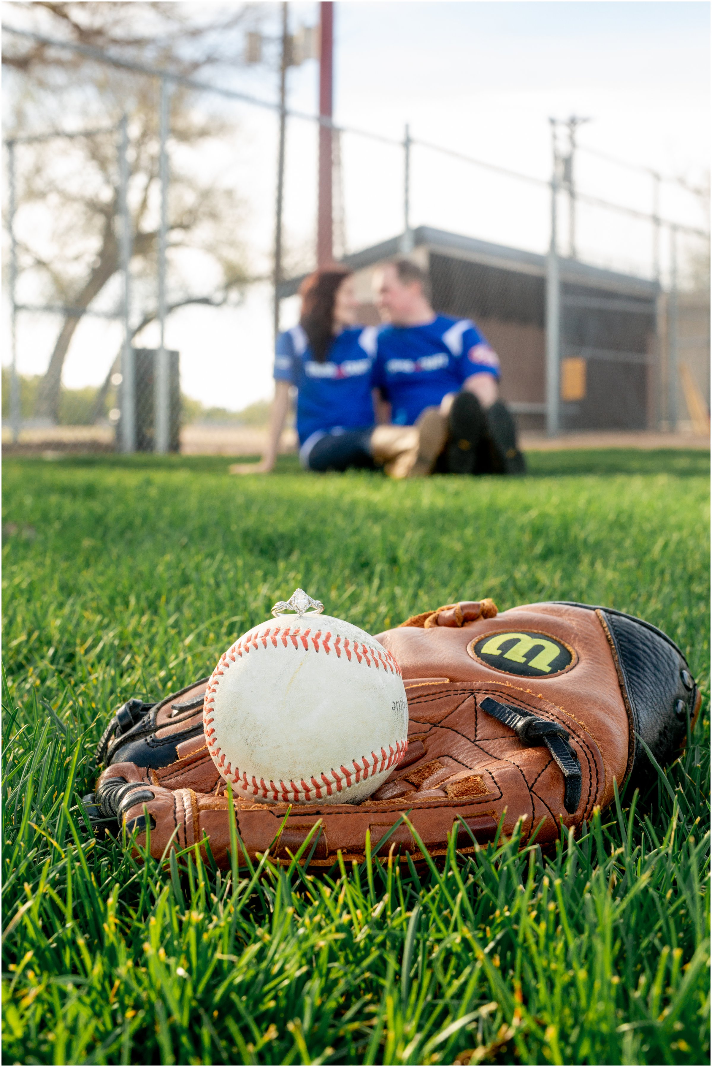 Engagement Session in Cheyenne Wyoming at Lions Park. Baseball themed with lots of flowers and blooming trees. 