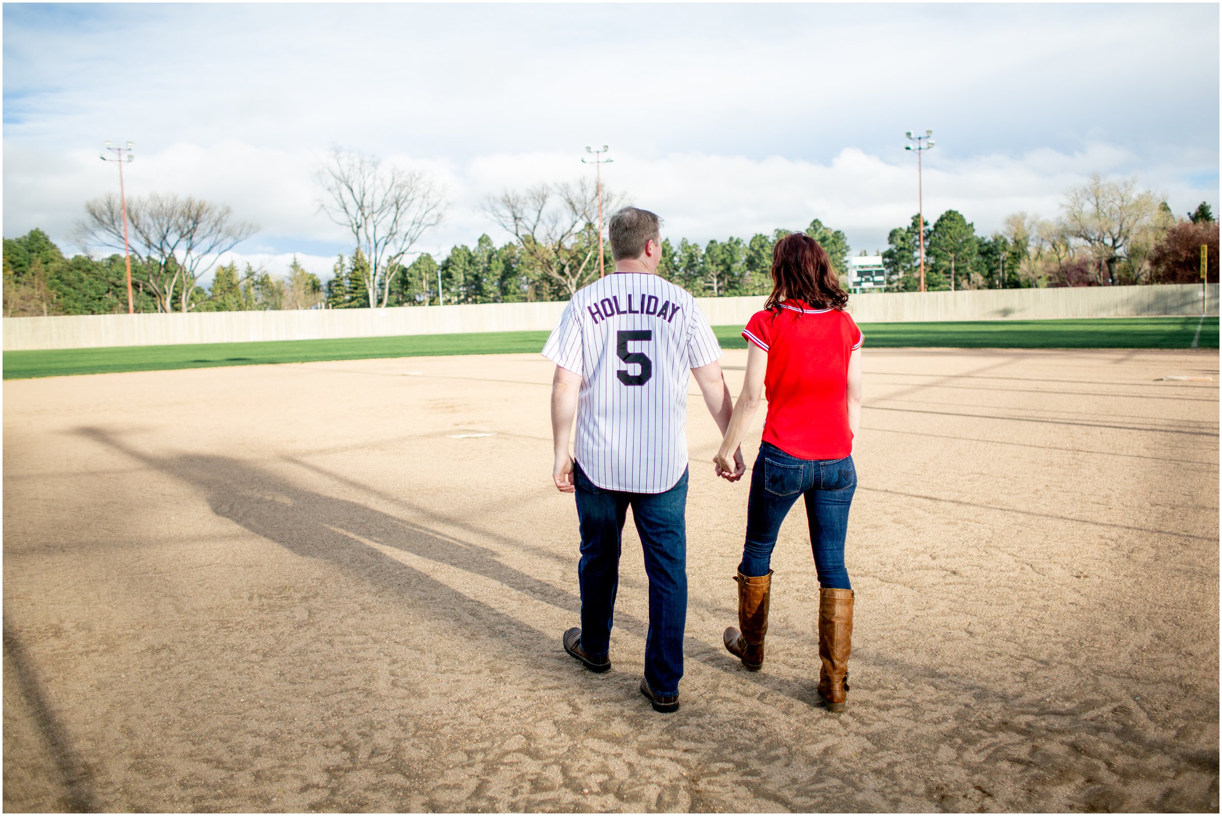 Engagement Session in Cheyenne Wyoming at Lions Park. Baseball themed with lots of flowers and blooming trees. 