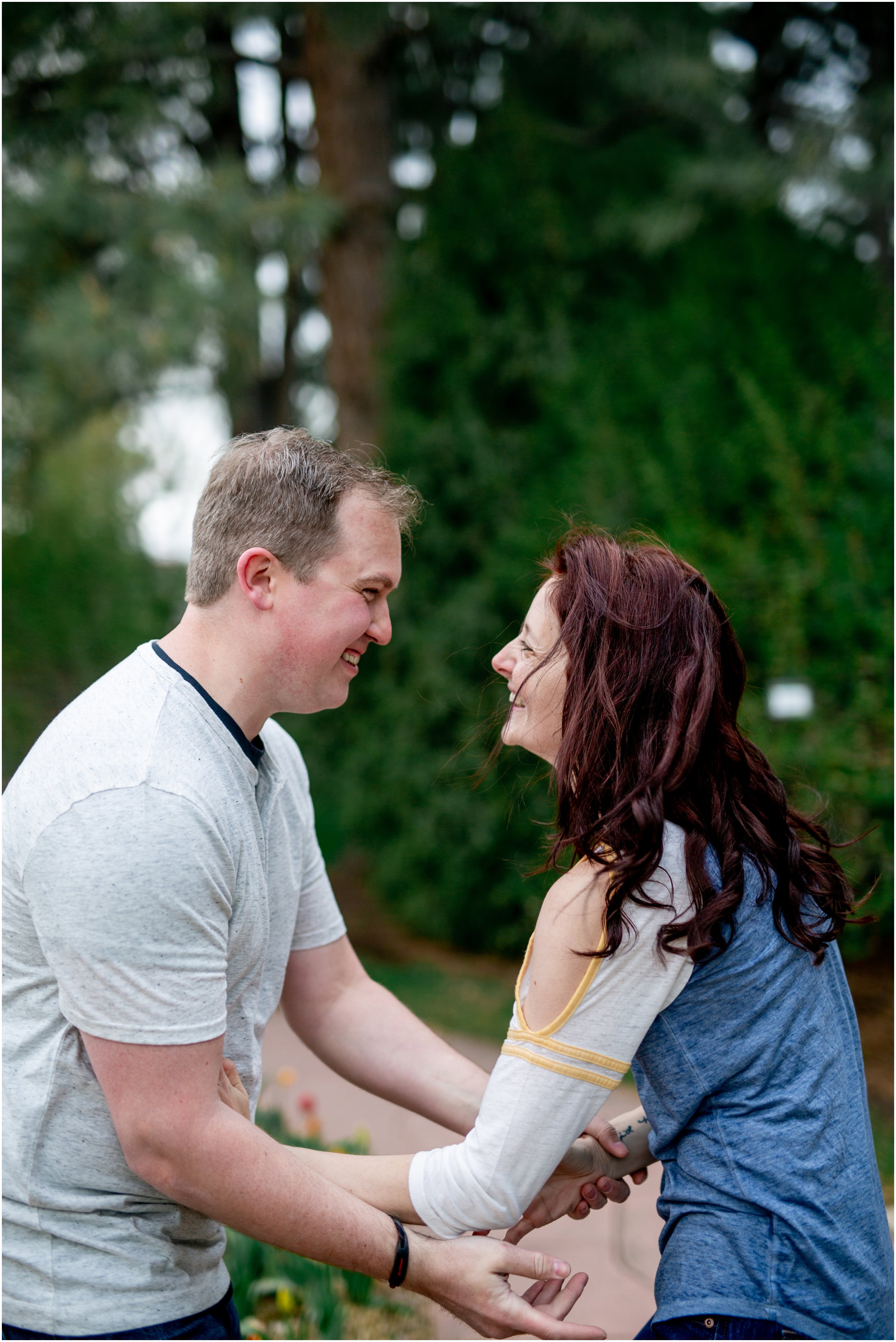 Engagement Session in Cheyenne Wyoming at Lions Park. Baseball themed with lots of flowers and blooming trees. 