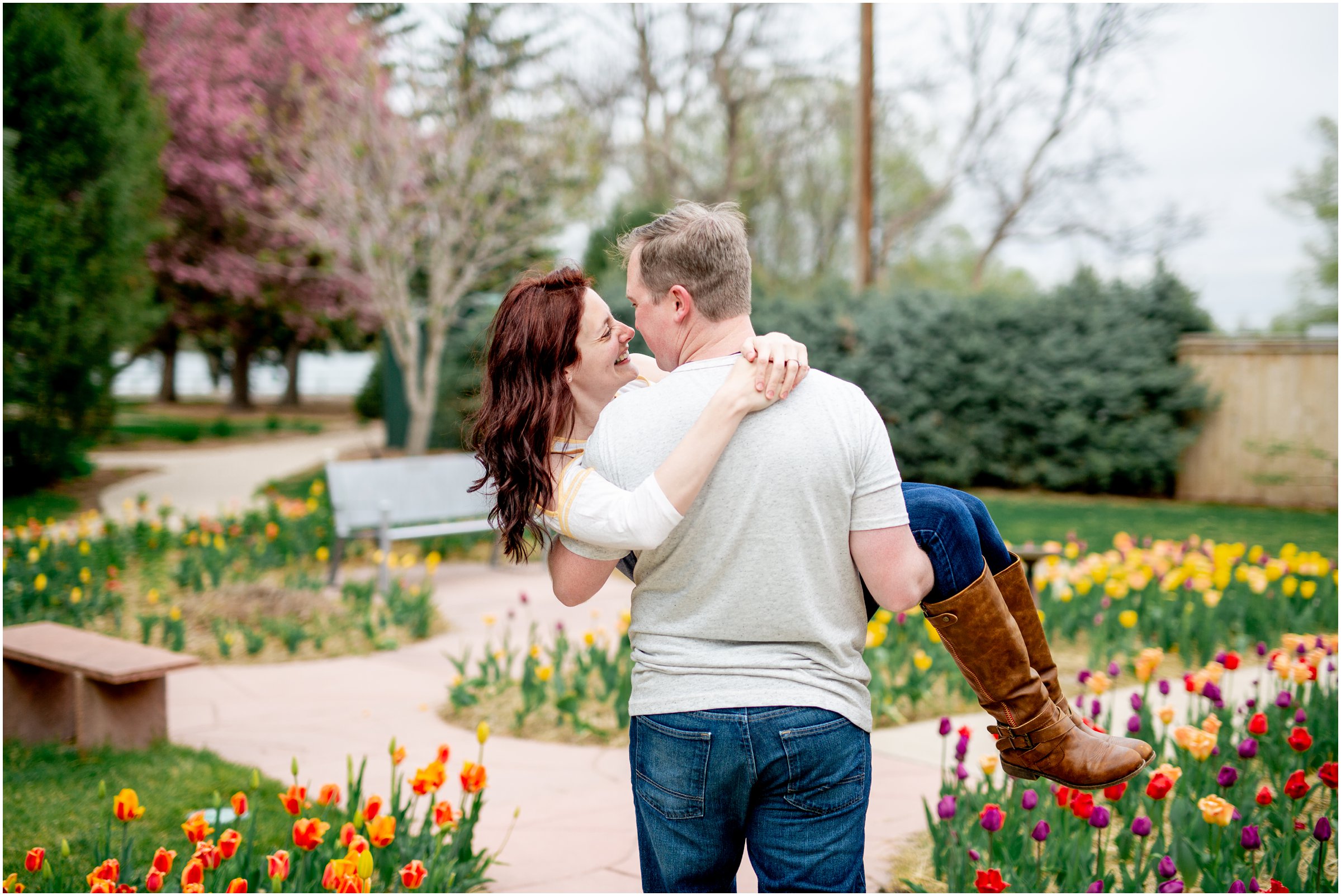 Engagement Session in Cheyenne Wyoming at Lions Park. Baseball themed with lots of flowers and blooming trees. 