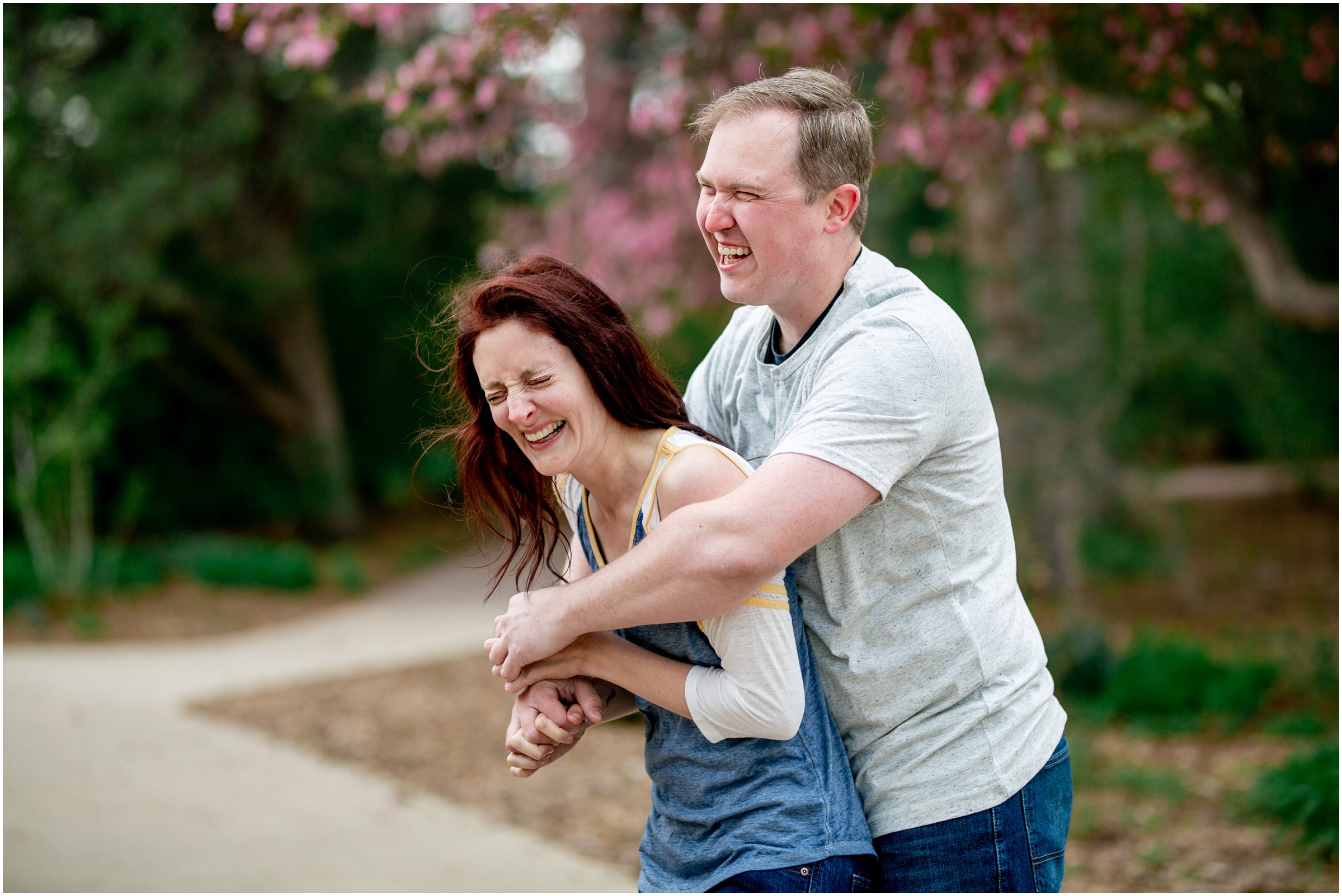 Engagement Session in Cheyenne Wyoming at Lions Park. Baseball themed with lots of flowers and blooming trees. 