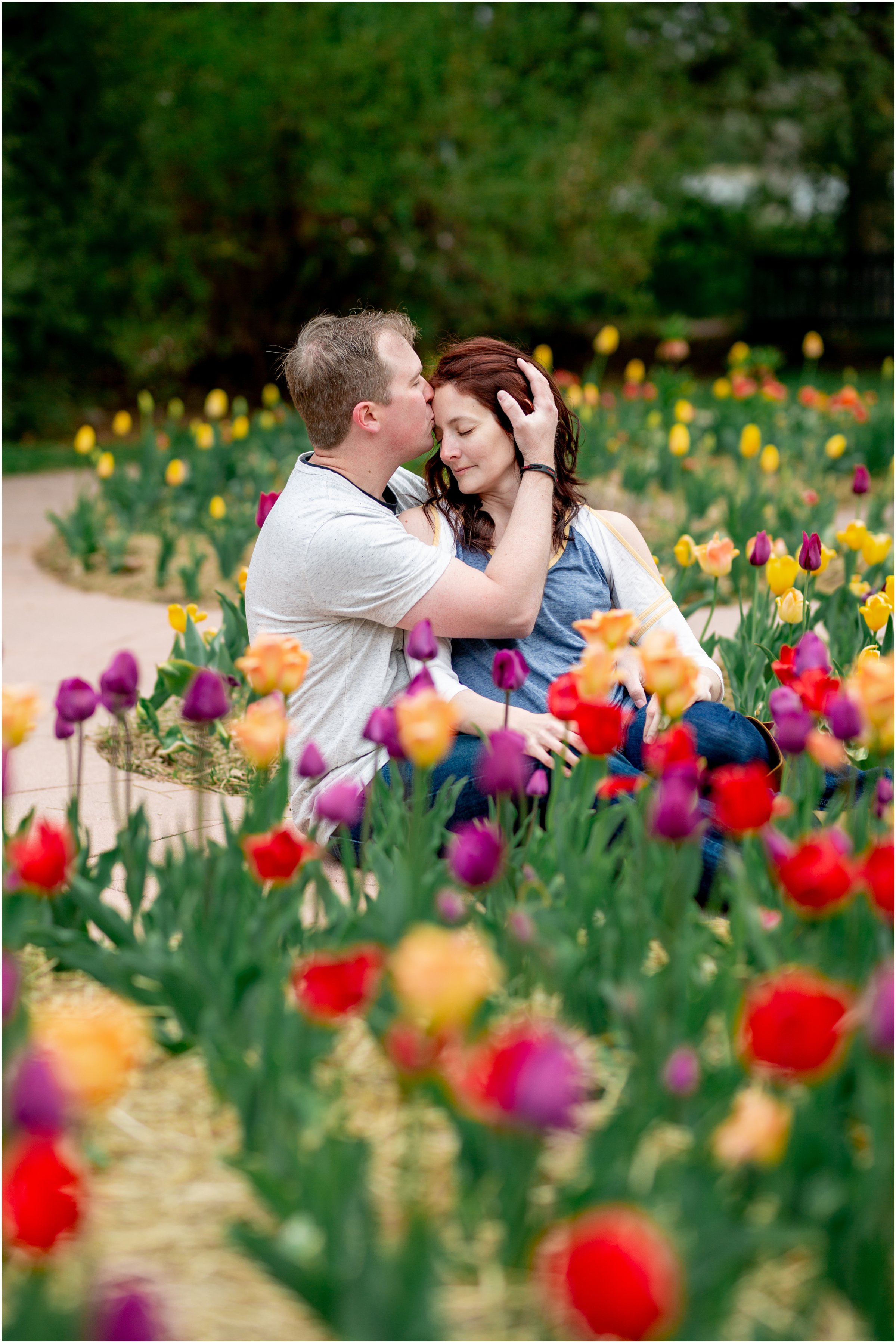 Engagement Session in Cheyenne Wyoming at Lions Park. Baseball themed with lots of flowers and blooming trees. 