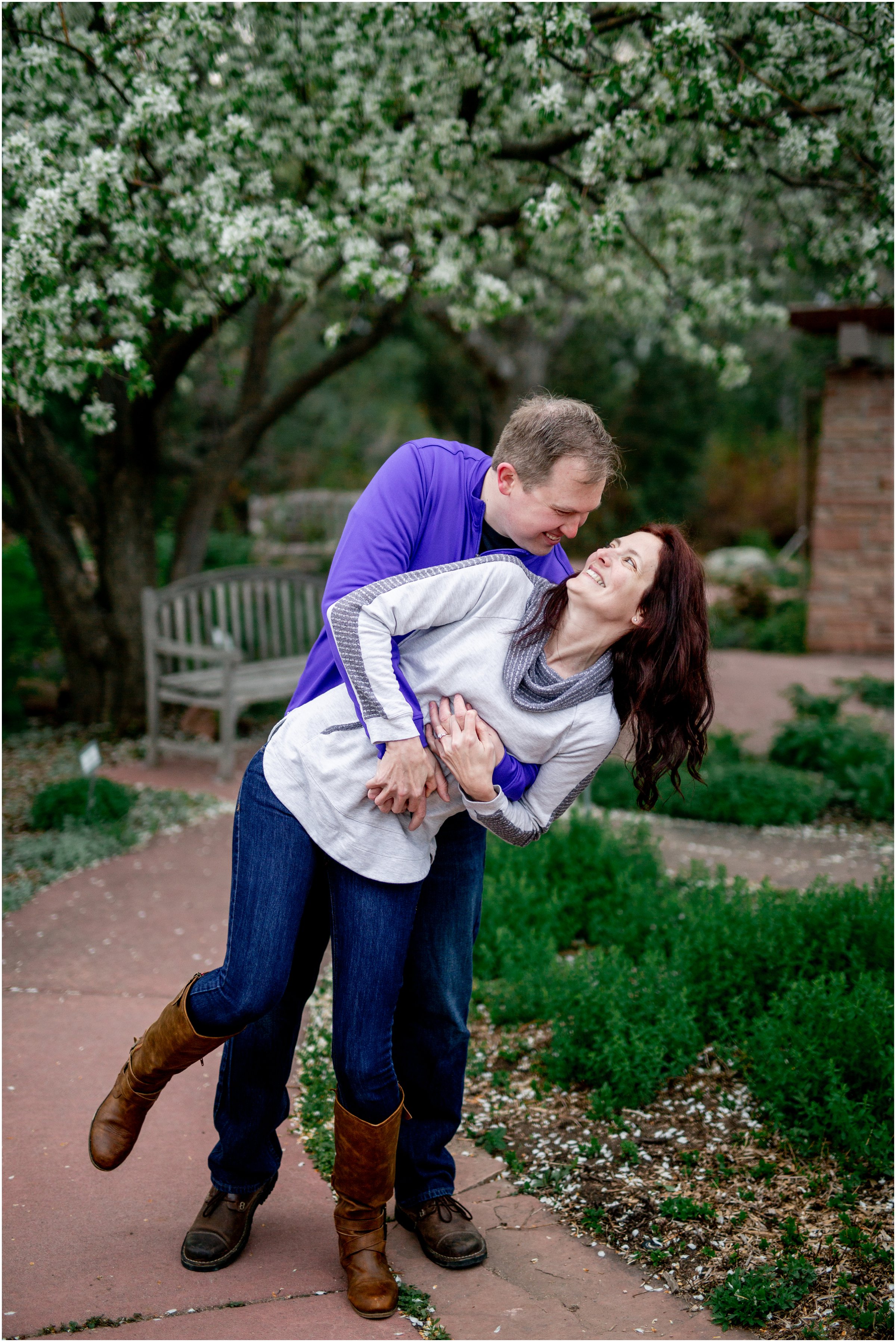 Engagement Session in Cheyenne Wyoming at Lions Park. Baseball themed with lots of flowers and blooming trees. 